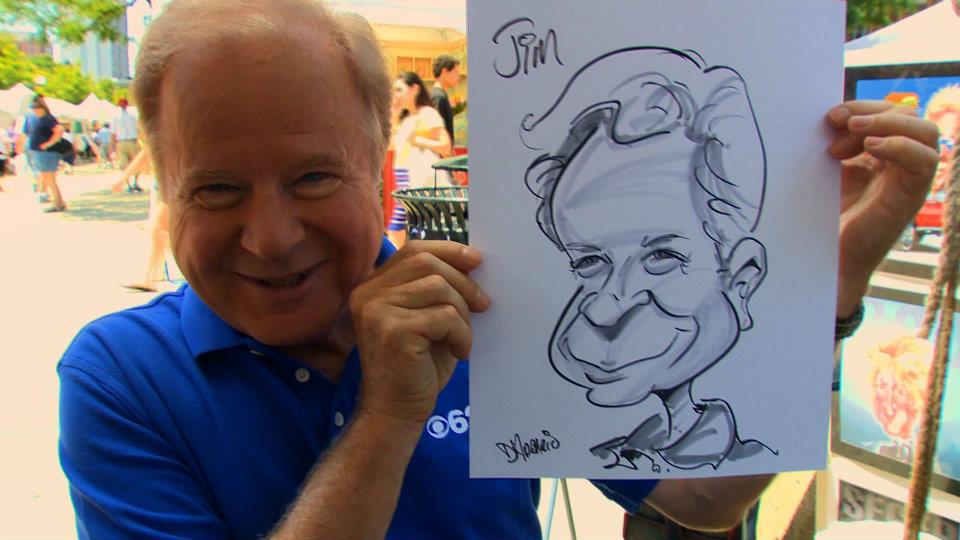 First Forecast Chief Meteorologist Jim Madaus shows off their caricatures drawn by Dan-D Caricatures' Dan D'Addario. (credit: Paul Pytlowany/CBS 62)