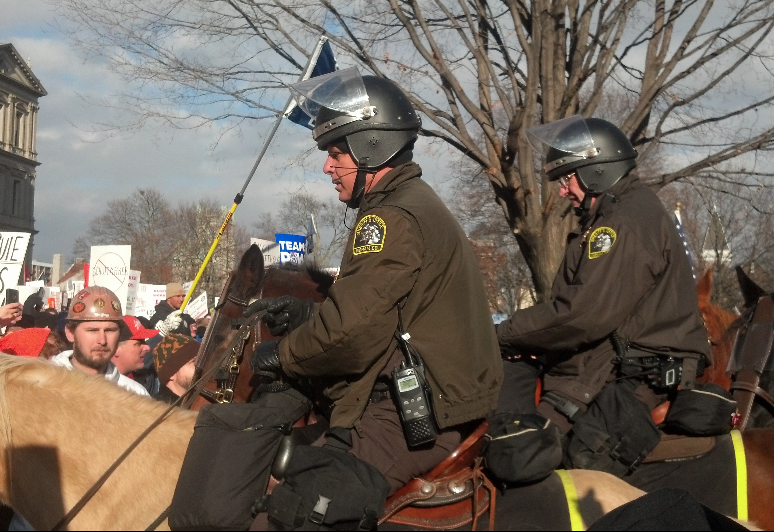 Mounted police in riot gear are seen among right-to-work protesters. (credit: WWJ/Ron Dewey)