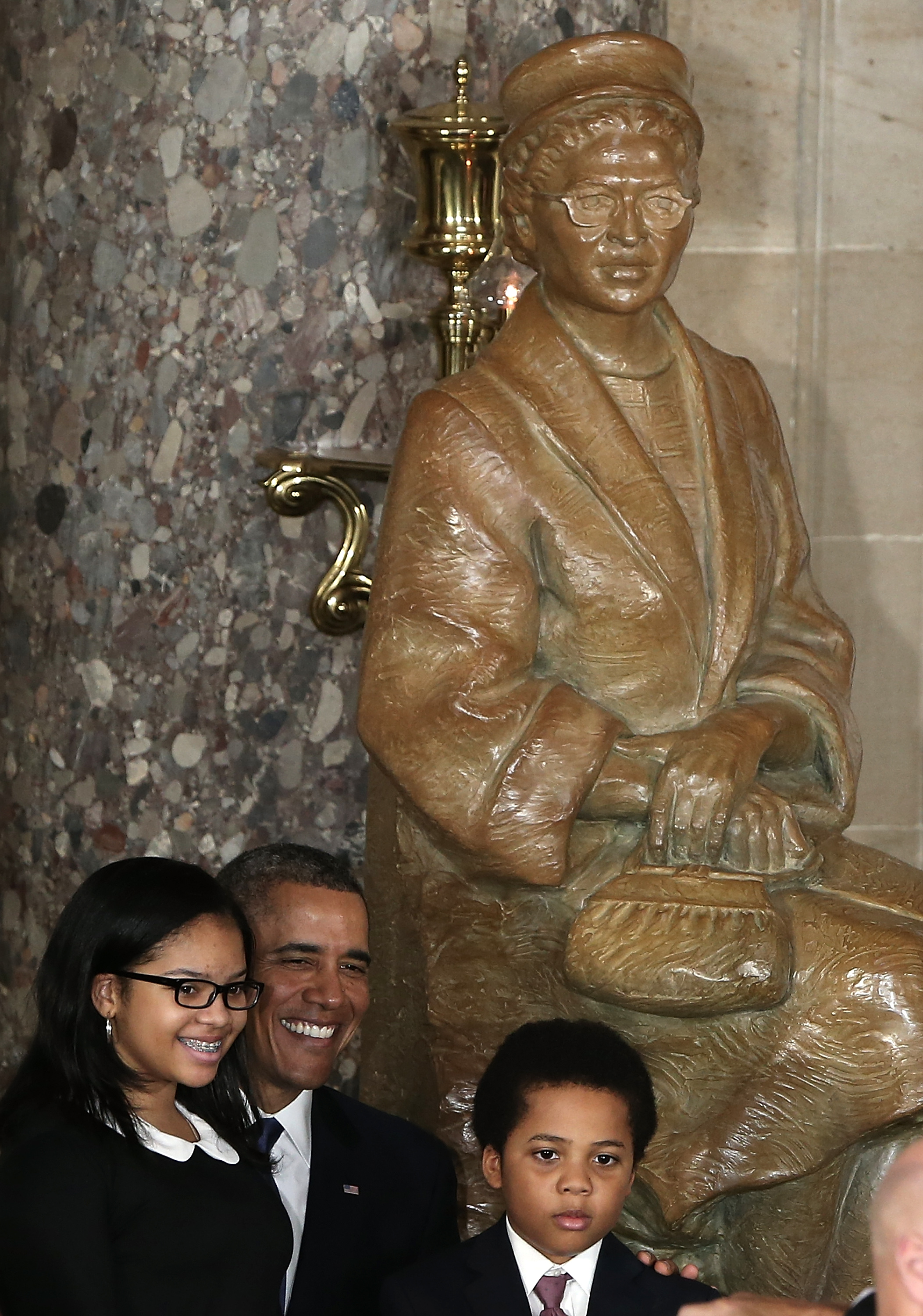 President Barack Obama (C) poses with guests following a ceremony to unveil a statue honoring the late civil rights activist Rosa Parks in Statutory Hall of the U.S. Capitol February 27, 2013 in Washington, DC. . (credit: Win McNamee/Getty Images)