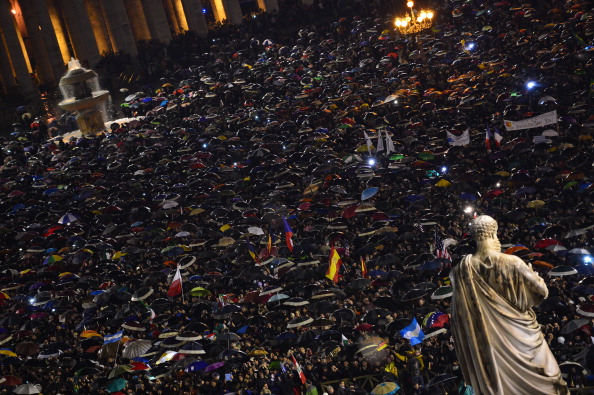 Faithfuls react in St Peter's Square after white smoke billowed from the chimney of the Sistine Chapel announcing that Catholic Church cardinals had elected a new pope during a conclave on March 13, 2013 at the Vatican. (credit: GIUSEPPE CACACE/AFP/Getty Images)