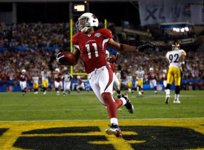 TAMPA, FL - FEBRUARY 01:  Wide receiver Larry Fitzgerald #11 of the Arizona Cardinals celebrates as he scores a 64-yard touchdown reception in the fourth quarter against the Pittsburgh Steelers during Super Bowl XLIII on February 1, 2009 at Raymond James Stadium in Tampa, Florida.