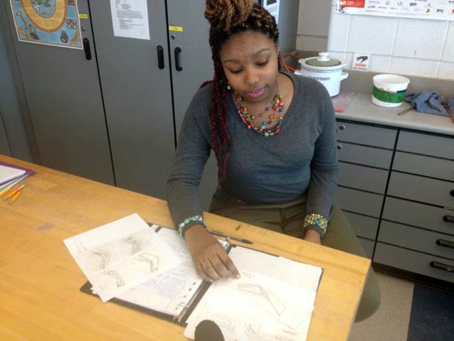 Student Abriana Walton shows WWJ how she created her jewelry. (Credit: Vickie Thomas/WWJ Newsradio 950)