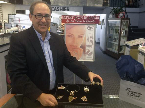 Michael Simmons shows off student-made jewelry on display at Simmons and Clark Jewelers in downtown Detroit. (Credit: Vickie Thomas/WWJ Newsradio 950)