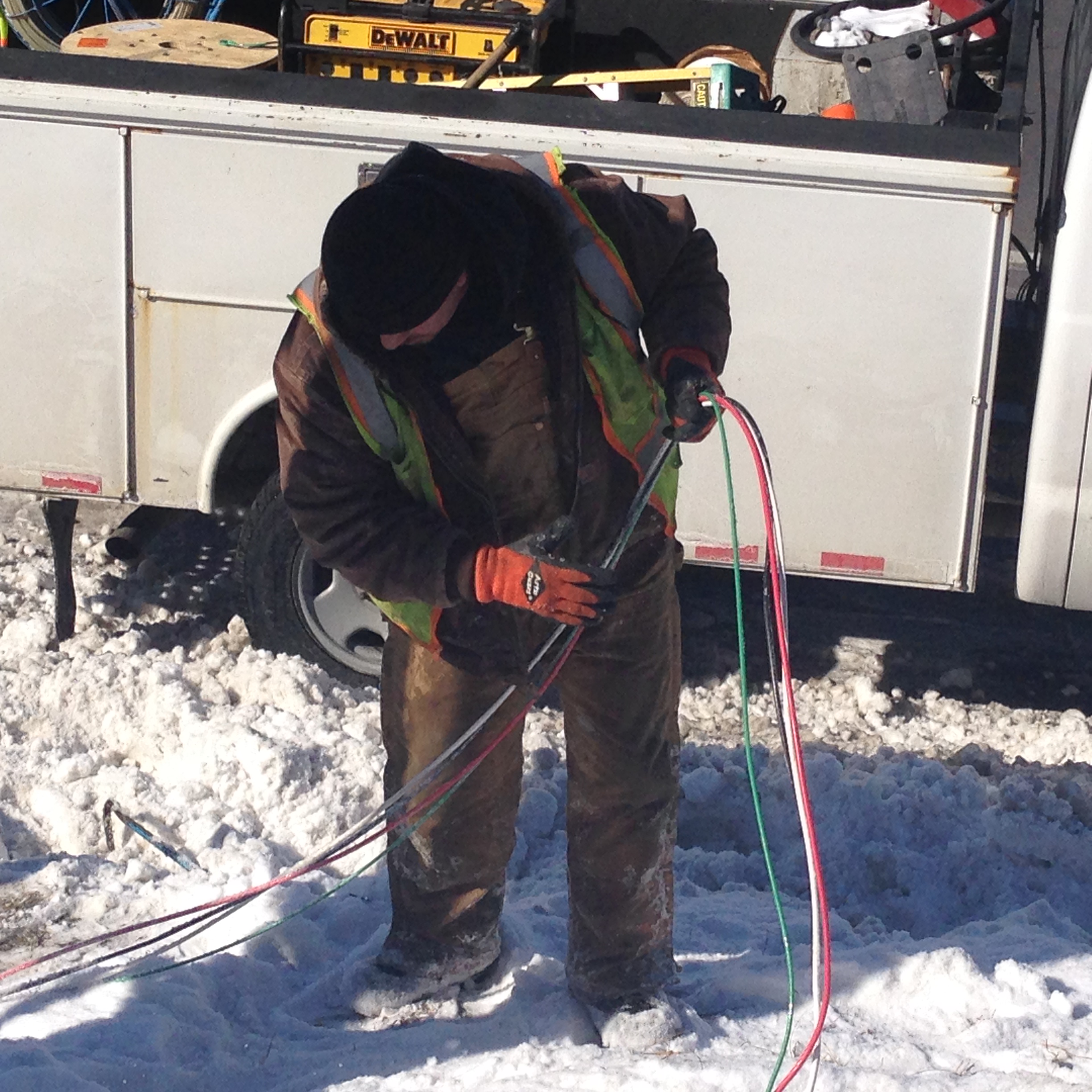  An unidentified worker from an electrical contracting company pulls new copper wire through the ground to replace wires that were stolen by copper thieves. (WWJ/Scott Lewis)