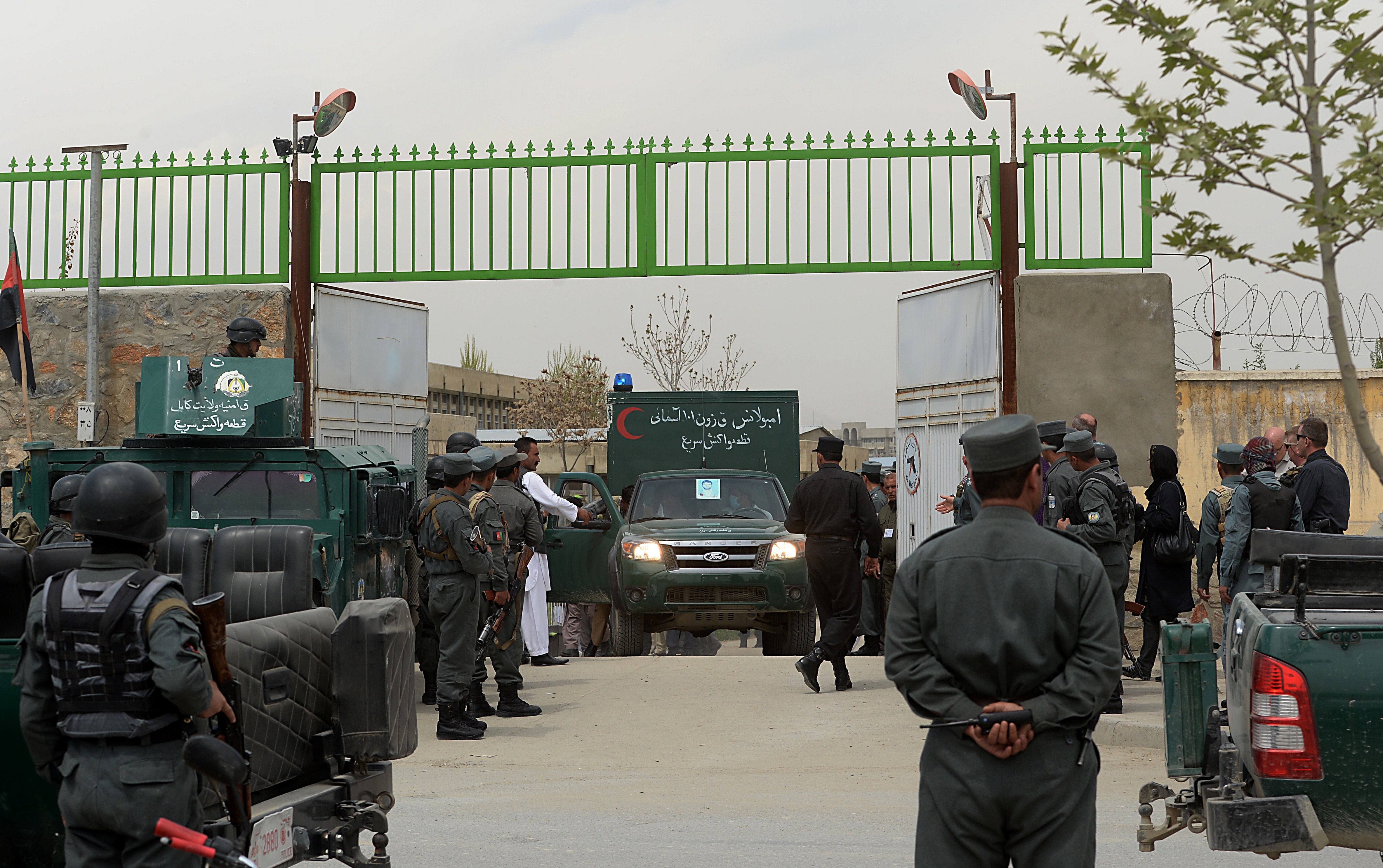 An ambulance carrying victims of a shooting leaves through the gate of the Cure hospital in the Afghan capital Kabul on April 24, 2014. A guard shot dead three foreigners at a US charity hospital in Kabul on April 24, the Afghan government said, with hospital staff saying at least one of the victims was a foreign doctor. 'As a result of shooting by a security guard of the Cure hospital... three foreign nationals have been killed and one female medical staff injured,' a statement from the ministry of interior said. AFP PHOTO/SHAH Marai (Photo credit should read SHAH MARAI/AFP/Getty Images)