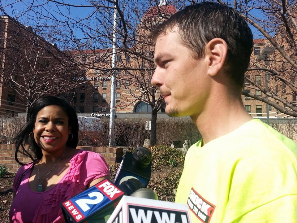 Joey, the son of injured Steven Utash, speaks outside the hospital. (WWJ/Kathryn Larson)