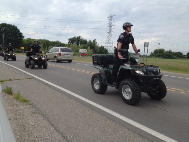 Michigan State police investigators are seen on ATVs near the Armada nature trail where, the day before, a teem's body was found.  (credit: Mike Campbell/WWJ)
