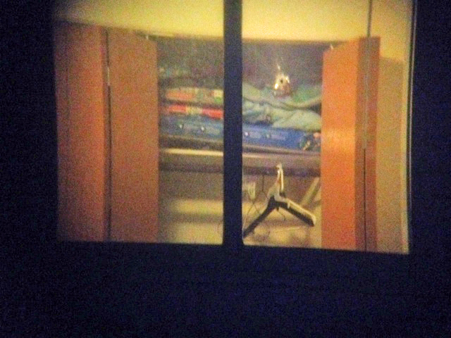 A bullet hole is seen in the upper right portion of a bedroom window where a sleeping Jakari Pearson, 8, was killed. (Credit: Mike Campbell/WWJ Newsradio 950)