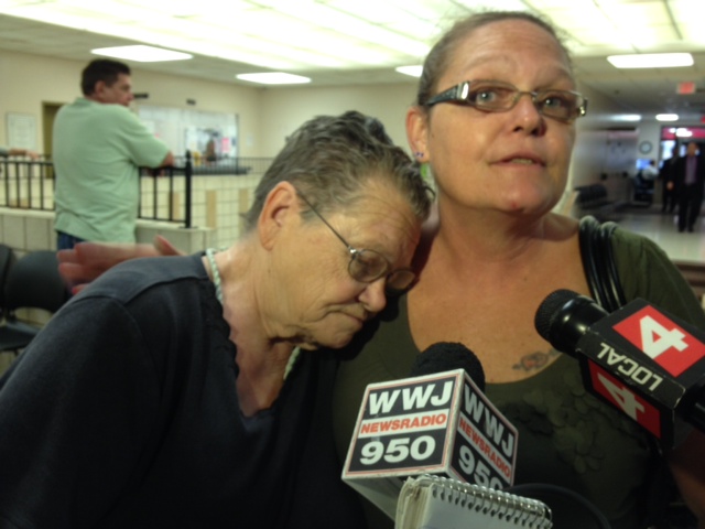 Loyd DeJohn's grandmother, Nettie Schwartz, rested her head on the shoulder of Dawn Hyslip, the victim's sister. (credit: Mike Campbell/WWJ)