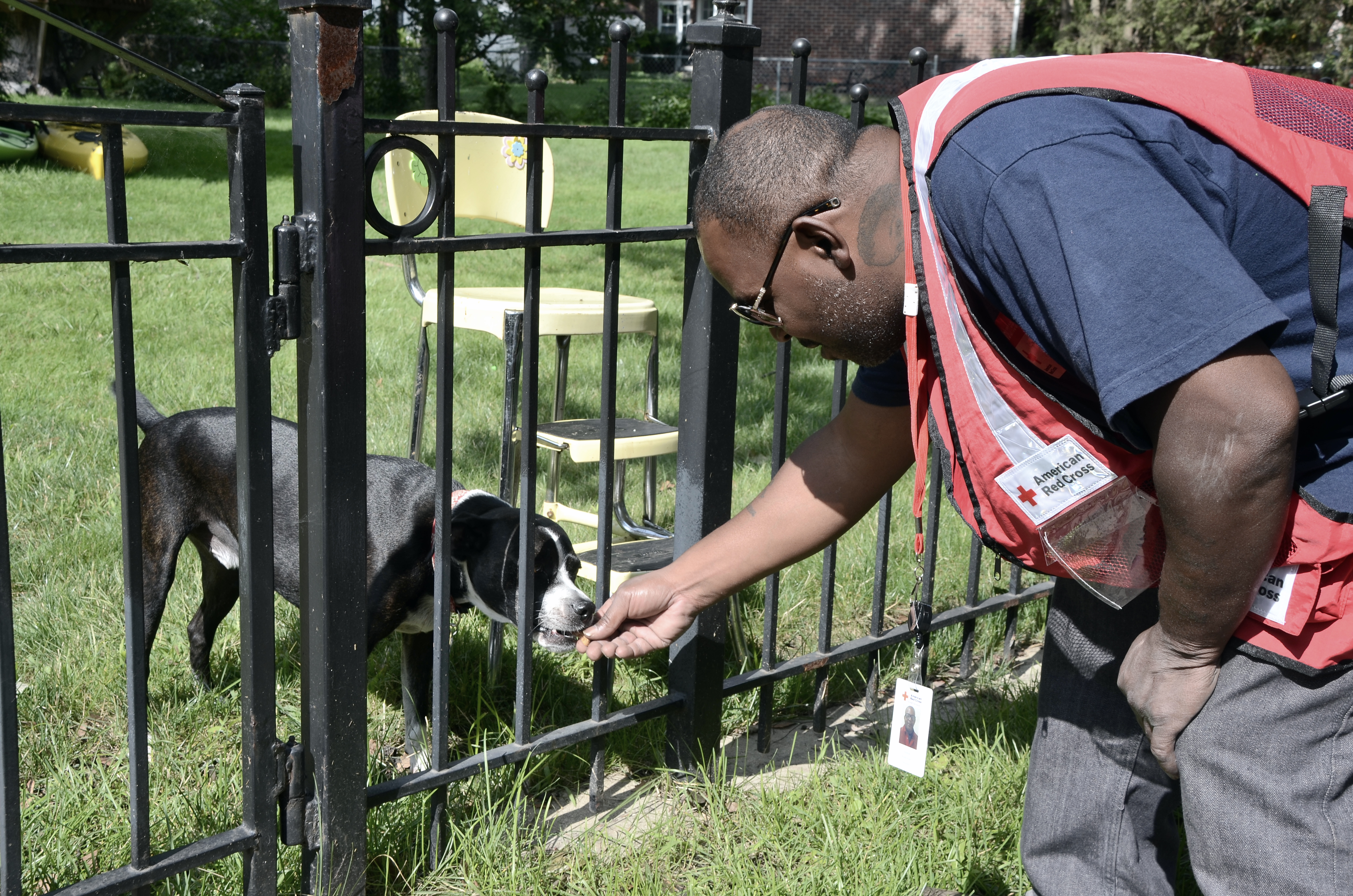 Damon Robinson takes a moment to give a treat to a family pet. 
