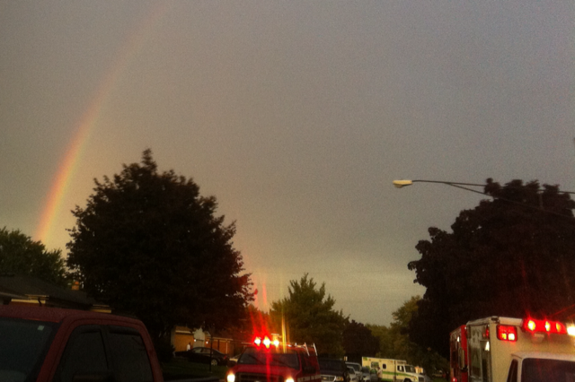 Rainbow in the sky as first responders work on fire damaged houses. (Credit/Gary Krupczak)