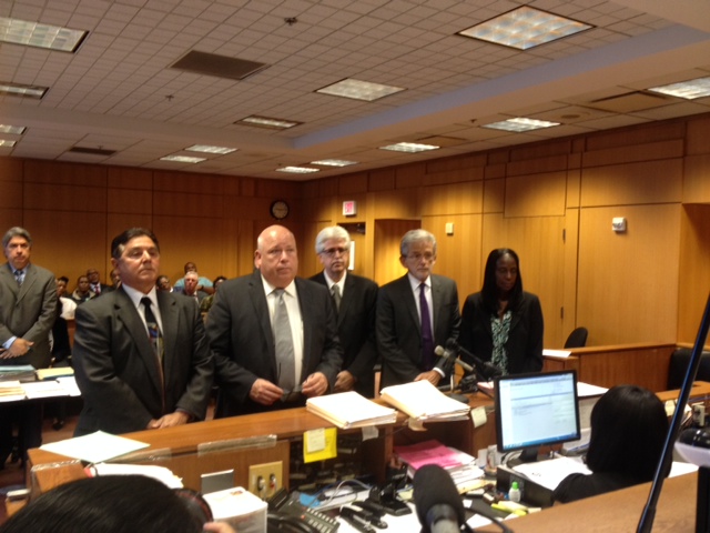 Standing in court with their attorneys, three people are arraigned on charges connected to the failed Wayne County Jail project. (Credit: Mike Campbell/WWJ Newsradio 950)